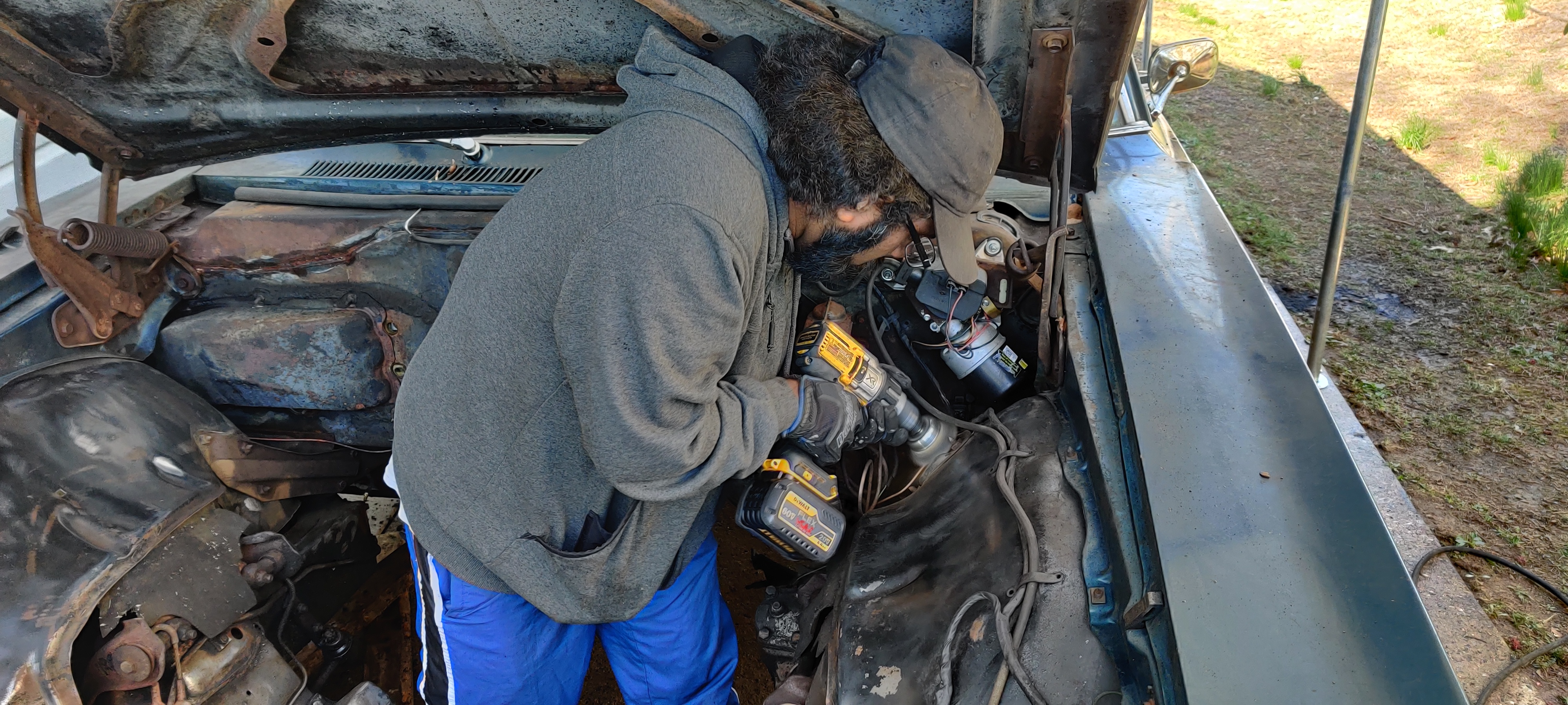 Stephen works on cleaning up the front left wheel well